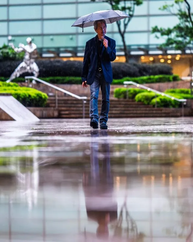 inclement weather visits hong kong- unfazed and focused, the people carry on