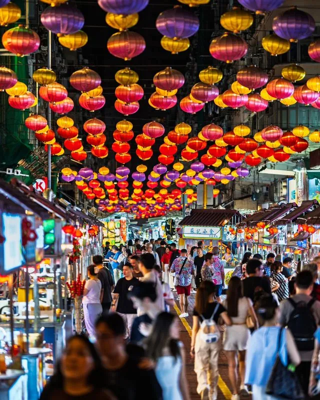 night markets in hong kong are not only full of food but also surprises- like a vendor using a cute corgi to try and rope you into eating with them