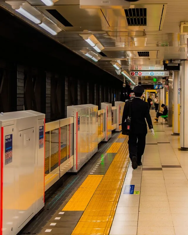 bound for haneda airport, car 7318 idles under the warm platform lights
