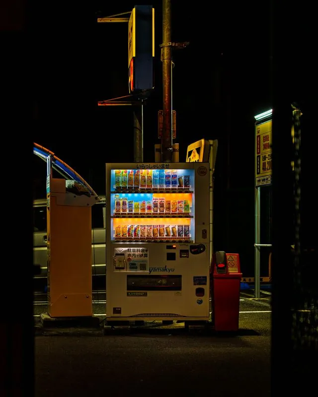 the vending machine glows alone on the street - the only light for blocks