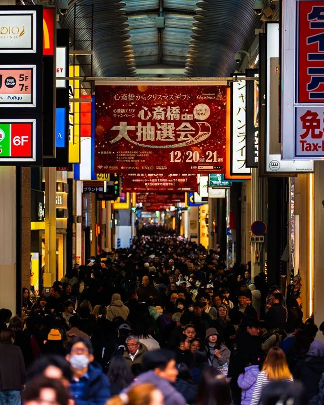 shinsaibashi arcade packed shoulder to shoulder under the holiday lottery banner